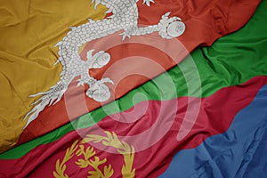 Waving colorful flag of eritrea and national flag of bhutan