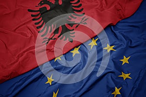 Waving colorful flag of european union and flag of albania