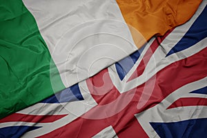 waving colorful flag of great britain and national flag of ireland