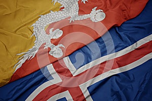 waving colorful flag of iceland and national flag of bhutan