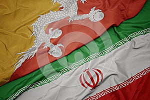 waving colorful flag of iran and national flag of bhutan