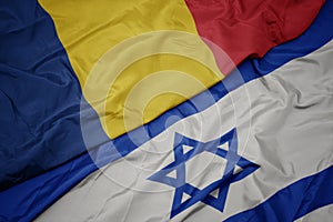 waving colorful flag of israel and national flag of romania