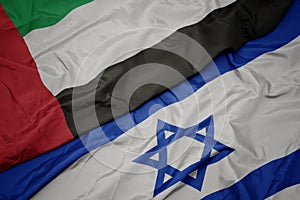 waving colorful flag of israel and national flag of united arab emirates