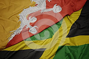 waving colorful flag of jamaica and national flag of bhutan