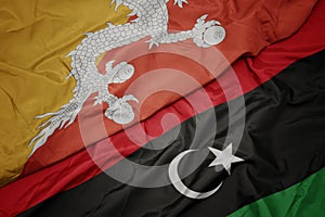 waving colorful flag of libya and national flag of bhutan