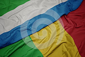 waving colorful flag of mali and national flag of sierra leone