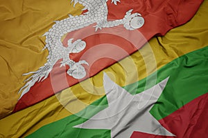 Waving colorful flag of myanmar and national flag of bhutan