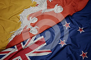 waving colorful flag of new zealand and national flag of bhutan