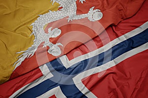 waving colorful flag of norway and national flag of bhutan