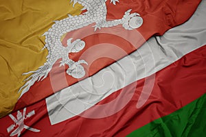 waving colorful flag of oman and national flag of bhutan