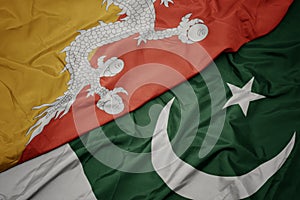 waving colorful flag of pakistan and national flag of bhutan