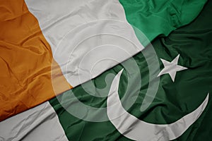 waving colorful flag of pakistan and national flag of cote divoire