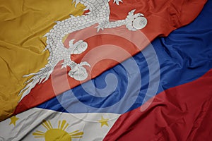 waving colorful flag of philippines and national flag of bhutan