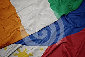 waving colorful flag of philippines and national flag of cote divoire