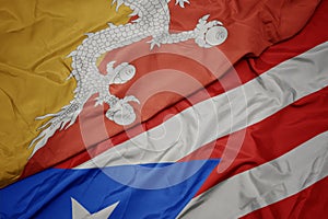 waving colorful flag of puerto rico and national flag of bhutan