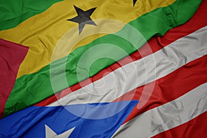 waving colorful flag of puerto rico and national flag of sao tome and principe photo