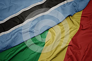 waving colorful flag of republic of the congo and national flag of botswana