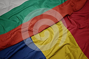 waving colorful flag of romania and national flag of bulgaria