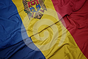 waving colorful flag of romania and national flag of moldova