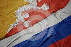 waving colorful flag of russia and national flag of bhutan