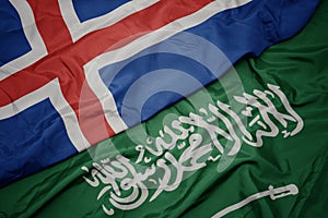 waving colorful flag of saudi arabia and national flag of iceland