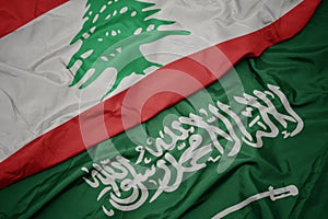 waving colorful flag of saudi arabia and national flag of lebanon