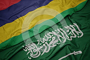 waving colorful flag of saudi arabia and national flag of mauritius