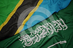waving colorful flag of saudi arabia and national flag of tanzania
