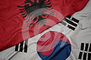 waving colorful flag of south korea and national flag of albania