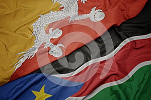 Waving colorful flag of south sudan and national flag of bhutan