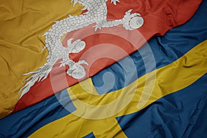 waving colorful flag of sweden and national flag of bhutan