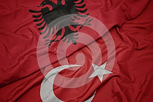 waving colorful flag of turkey and national flag of albania
