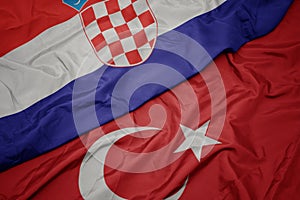 waving colorful flag of turkey and national flag of croatia