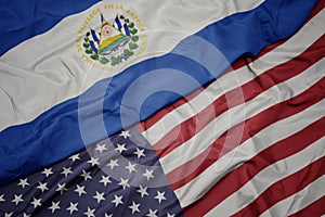 waving colorful flag of united states of america and national flag of el salvador photo