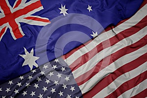 waving colorful flag of united states of america and national flag of australia