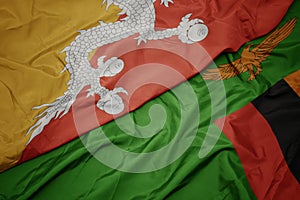 Waving colorful flag of zambia and national flag of bhutan