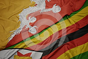 Waving colorful flag of zimbabwe and national flag of bhutan