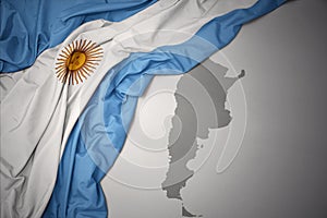 Waving colorful national flag and map of argentina.