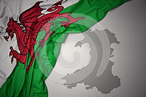 Waving colorful national flag and map of wales. photo