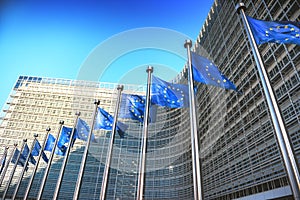 Waving EU flags in front of European Commission in Brussels