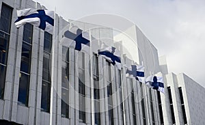 Waving Finnish flags against of The Finlandia Hall photo