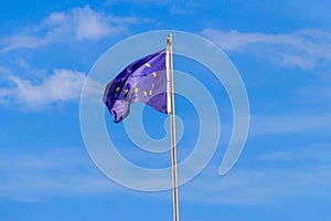 Waving flag of European Union against blue sky