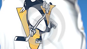 Waving flag with Pittsburgh Penguins NHL hockey team logo, close-up. Editorial 3D rendering