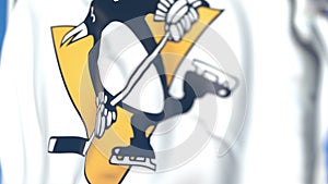 Waving flag with Pittsburgh Penguins NHL hockey team logo, close-up. Editorial 3D rendering
