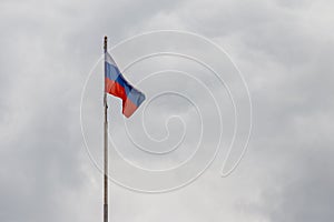 Waving flag of Russia against cloudy sky