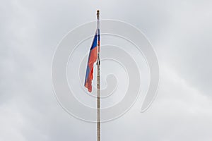 Waving flag of Russia against cloudy sky