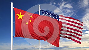 Waving flags of China and USA on flagpole