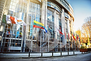 Waving flags in front of European Parliament building, Brussels