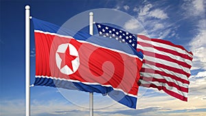 Waving flags of North Korea and USA on flagpole