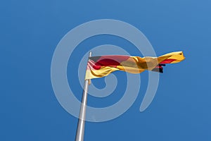 Waving German flag against a blue sky. photo
